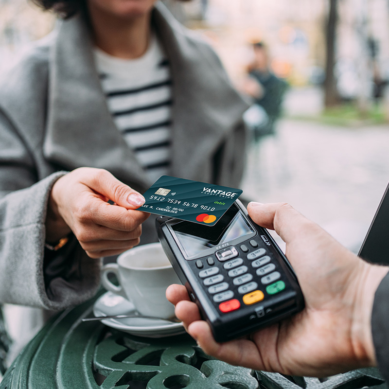Woman purchasing coffee with Vantage debit card