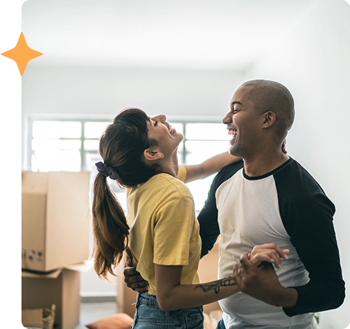 First-time homeowners dancing in new house