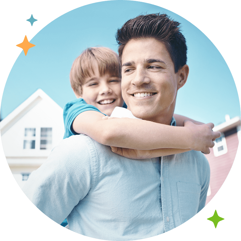 A father and son giving a piggy back ride