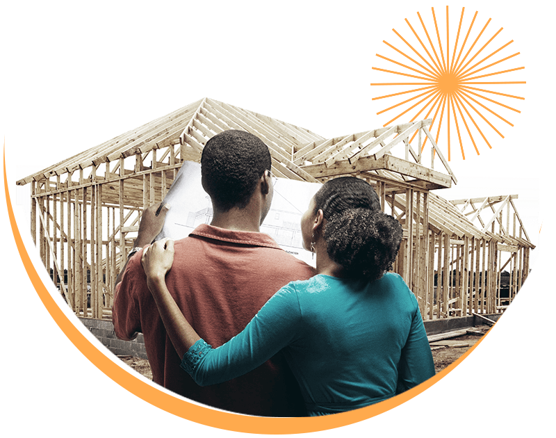 A couple looking at the blueprints for their new house