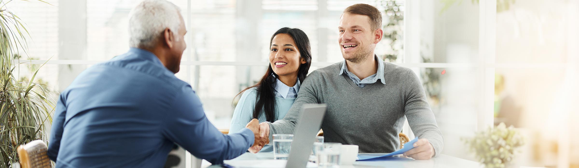 Customers shaking hands with a Vantage employee