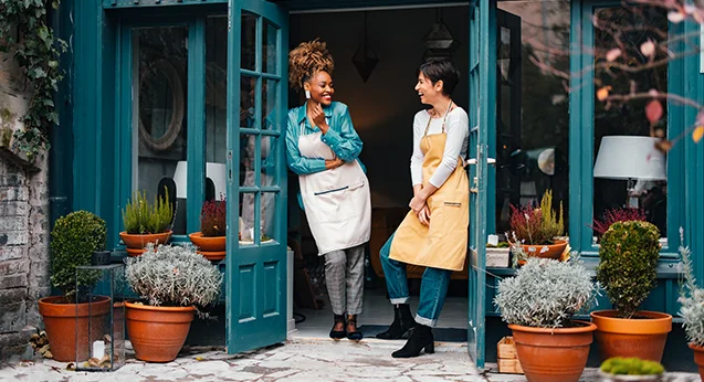 Florist shop owners standing at entrance