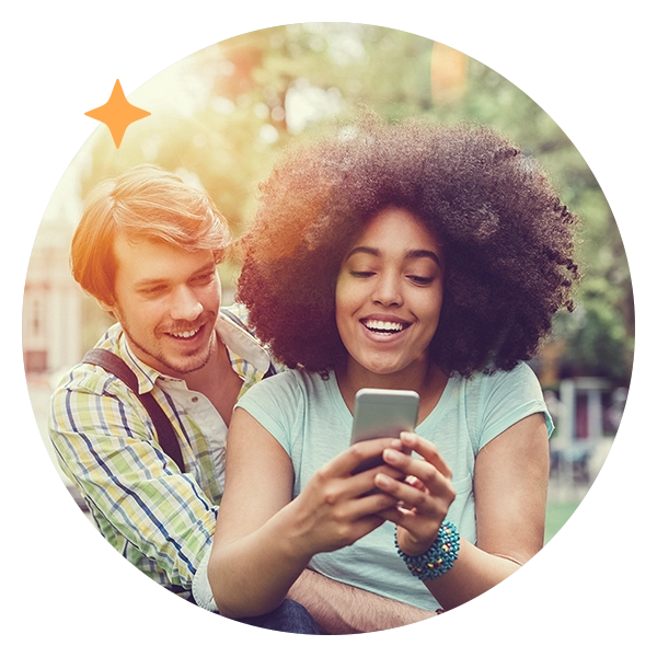 Two people looking at a mobile phone