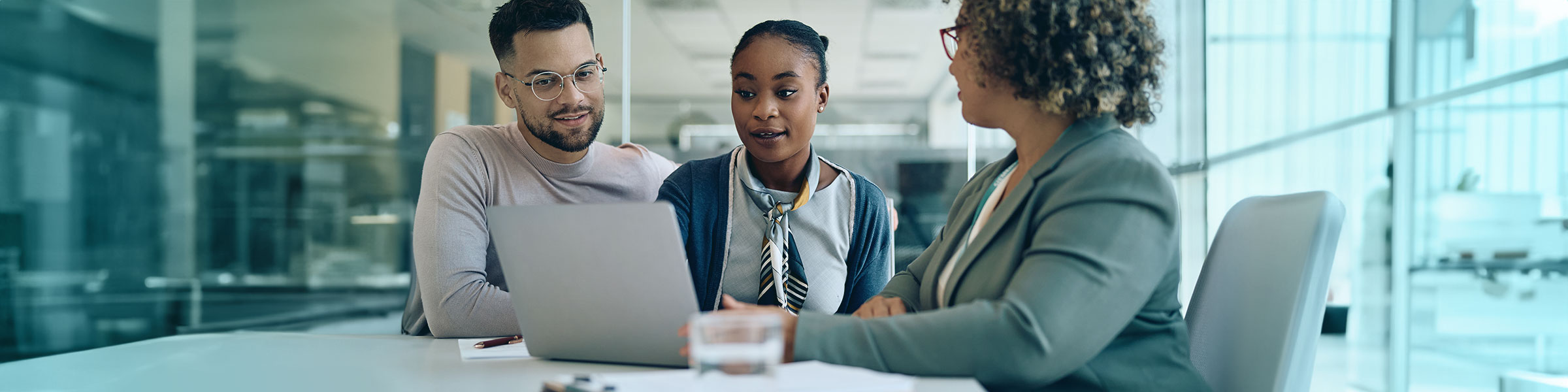 Two customers speaking with a loan officer