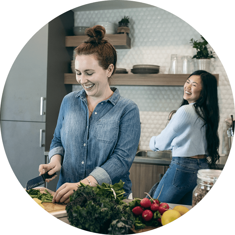 Two women cooking dinner in the kitchen