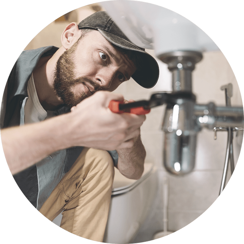 A plumber working on a pipe