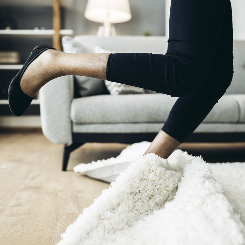 woman stumbling on rug