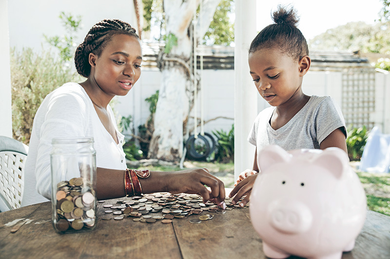 mom and daughter counting coins